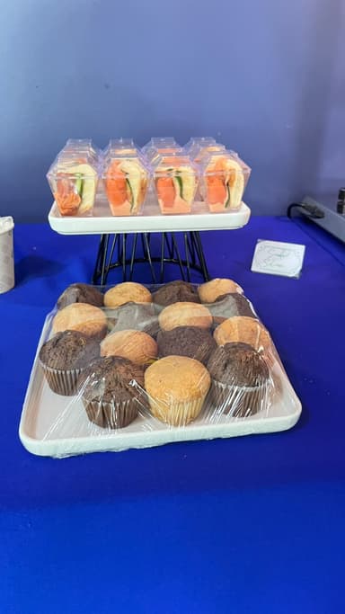 Salmon sandwich boxes above a tray of muffins